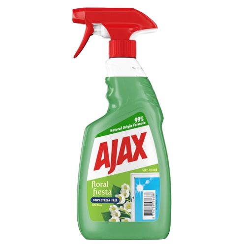 750-ml butelka sprayu do mycia szyb Ajax na białym tle. Butelka jest przezroczysta zielona i ma czerwoną głowicę sprayu z czerwoną szyjką. Etykieta jest głównie jasnozielono-biała, z dużym czerwonym logo Ajax. Kluczowy tekst na etykiecie zawiera: "Floral Fiesta", "100% Bez Smug*", "Spring Flowers" (Zapach wiosenny) oraz "Formuła o 99% Pochodzenia Naturalnego". W prawym dolnym rogu znajduje się panel przedstawiający czyste, słoneczne okno i białe kwiaty jaśminu, wraz z kodem kreskowym.